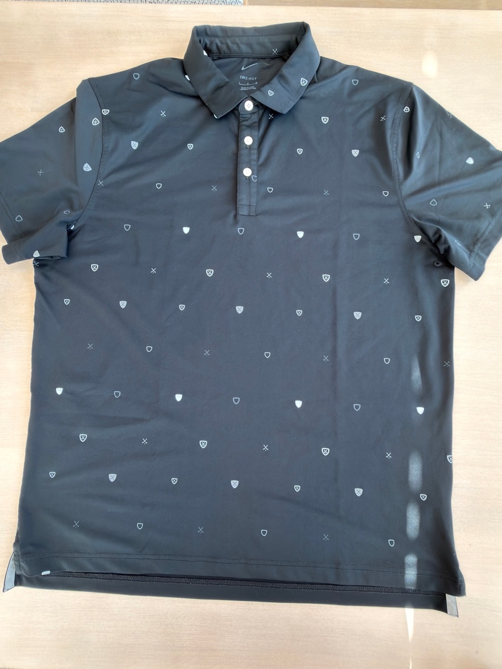Nike Men's Black Micro-Print Polo Shirt with Subtle Shield Motif